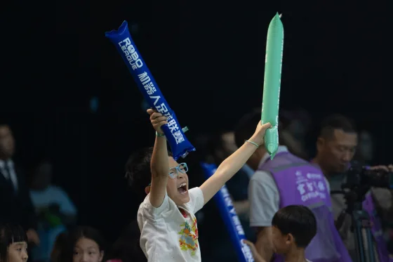 A fan cheering on the robot athletes in Beijing on Saturday