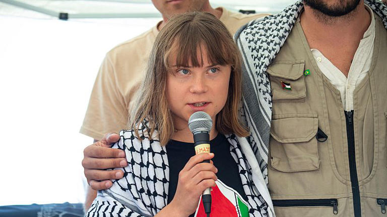 Climate activist Greta Thunberg flanked by Thiago Avila from a human rights organization meets with journalists in Catania
