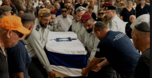 Israeli soldiers carry a coffin covered with the Israeli flag during the funeral of Sergeant First Class Benyamin Asulin, July 8, 2025, in Haifa, Israel.  